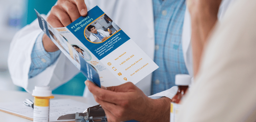 Broulim's Pharmacist Providing Medication Therapy Treatment With A Pamphlet